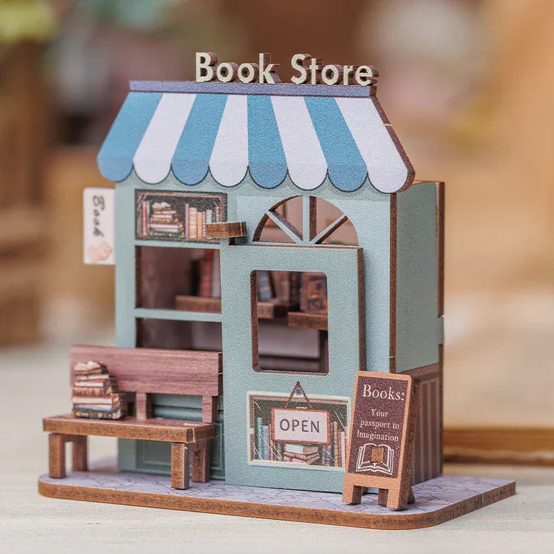 Miniatur-Buchladen-Modellbausatz mit blau-weiß gestreifter Markise und Bank