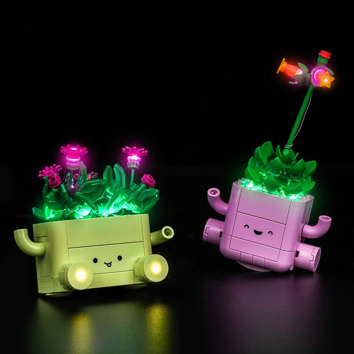 Das LEGO-Set Schaukelnde Pflanzen in Grün und Rosa, effektvoll inszeniert mit bunten BrickBling LED-Lichtern vor schwarzem Hintergrund.