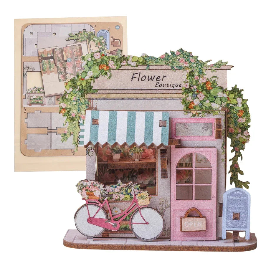 Miniatur-Blumenboutique-Modell mit rosa Fahrrad und Blumenkorb