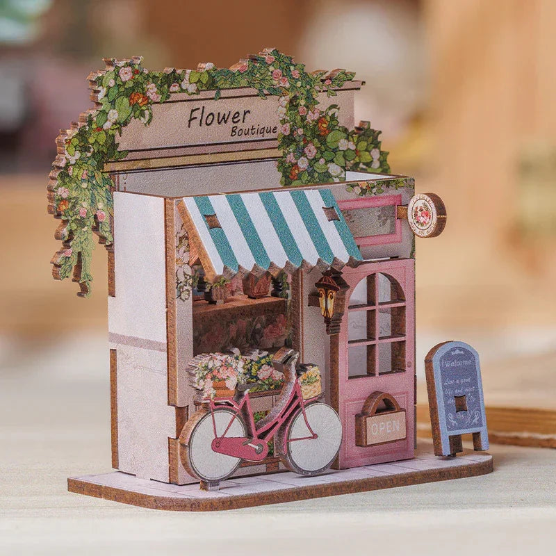 Miniatur-Blumenboutique mit rosa Fahrrad und Markise